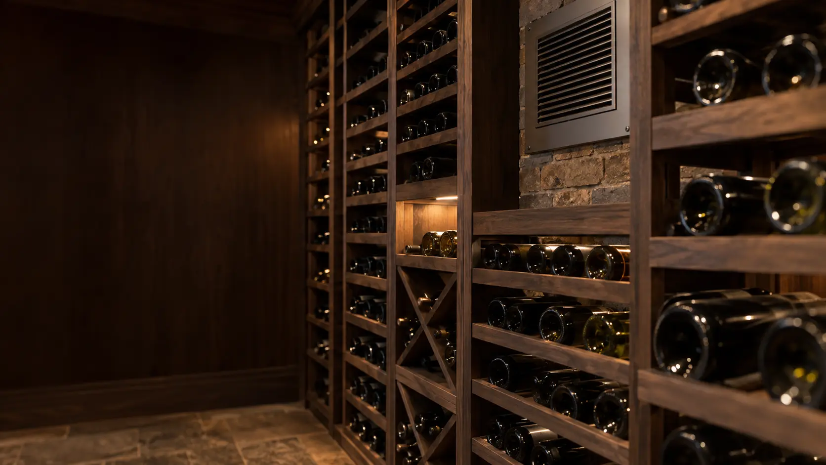 A wine cellar with a through-wall cooling unit and dark wood paneling, seen close and low along the racks.