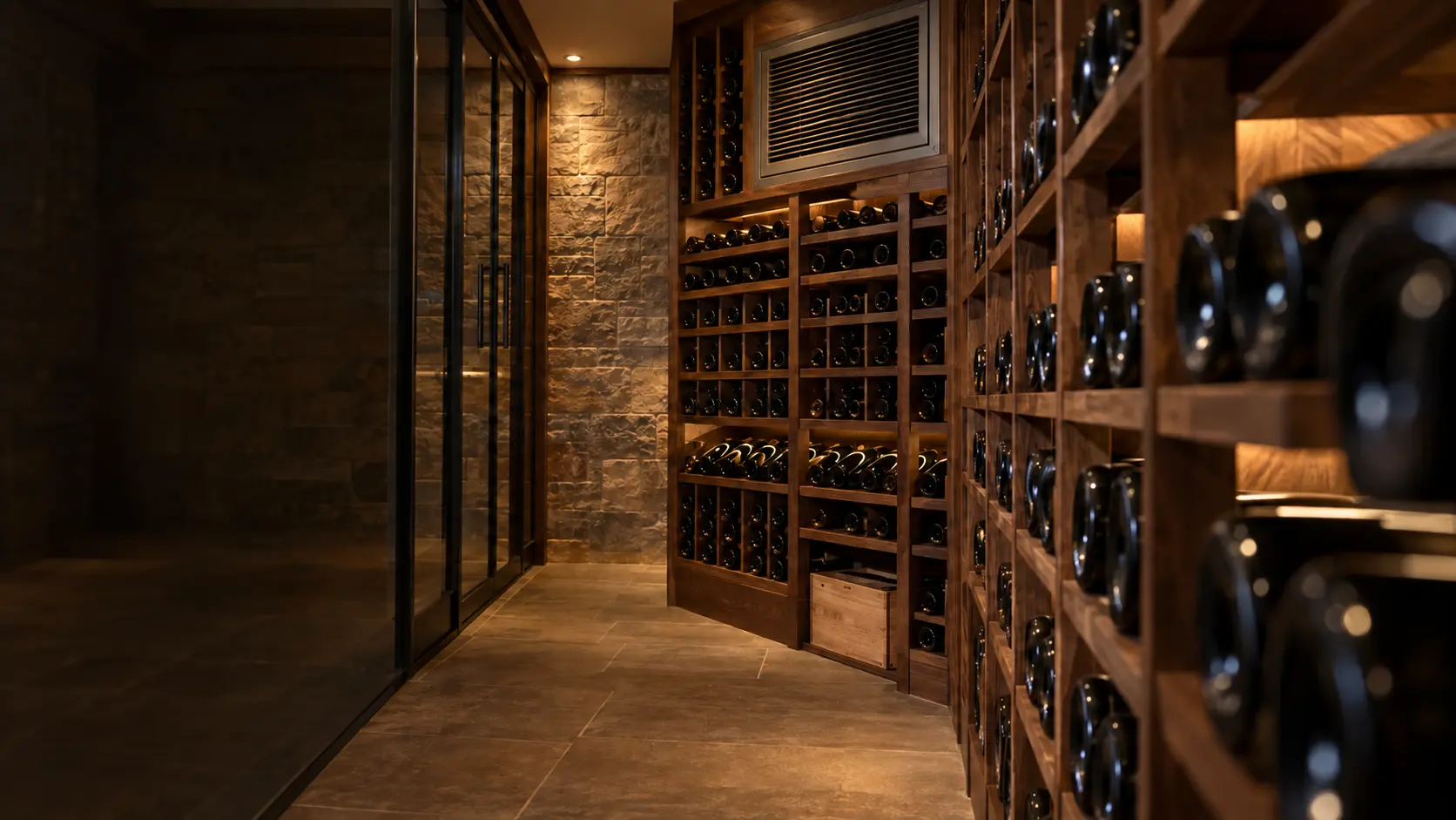 A wine cellar with a through-wall cooling unit and glass walls, seen close and low along the racks.