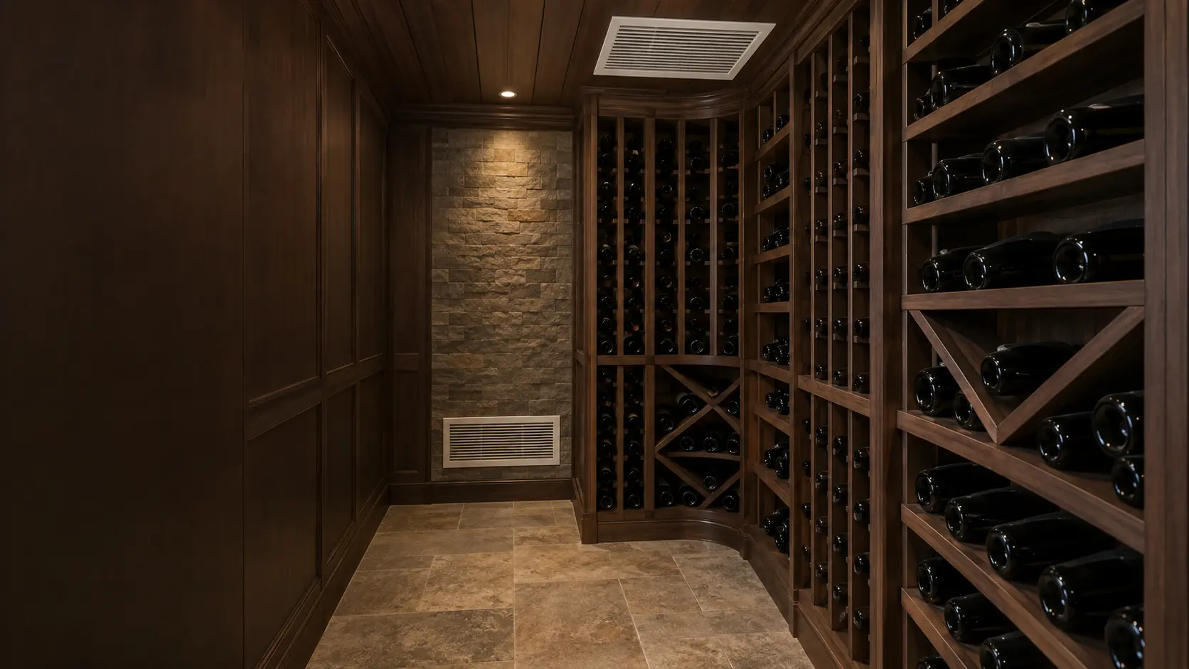 A wine cellar in a US home seen from inside, a white rectangular supply grille for its cooling unit set in the wood-paneled ceiling above tall dark racks of wine bottles, a matching return grille low on the far wall, soft even lighting.